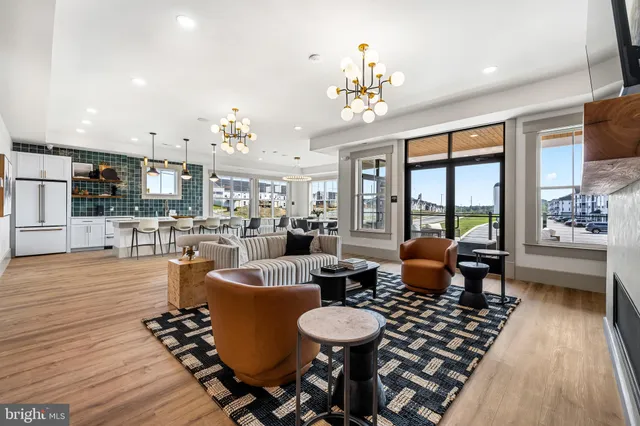 a dining room with wooden floor a chandelier a glass table and chairs