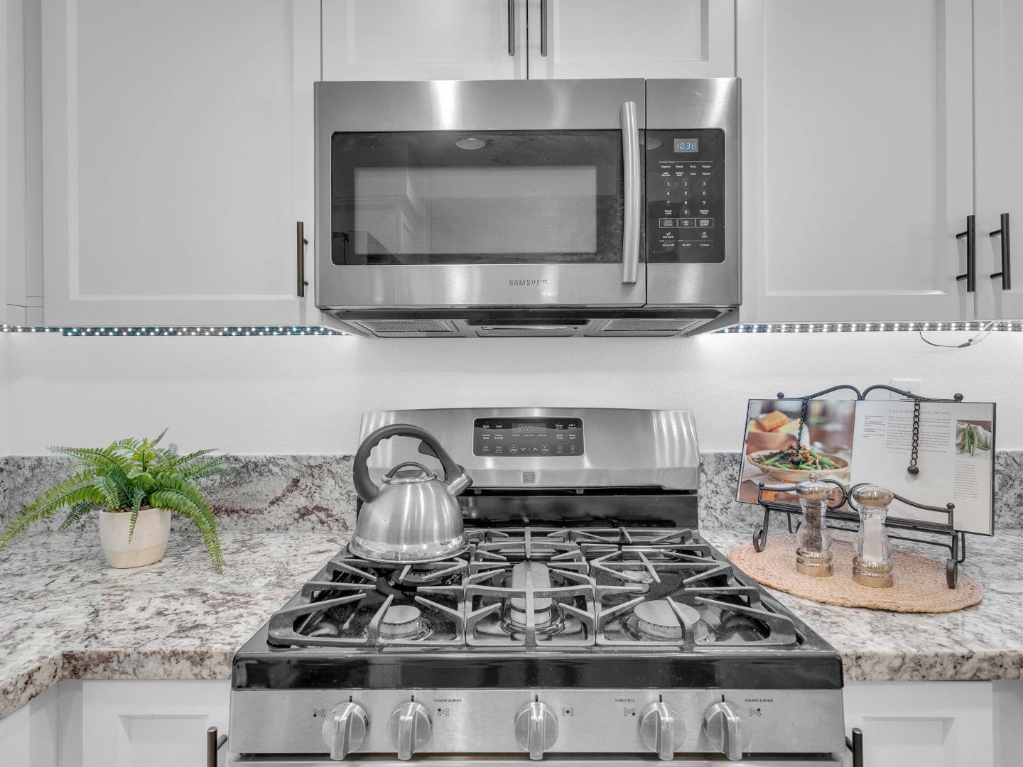 6978 Gregorich Drive, Unit E San Jose, CA 95138 - Photo 13 of 24 a kitchen with a stove and a microwave