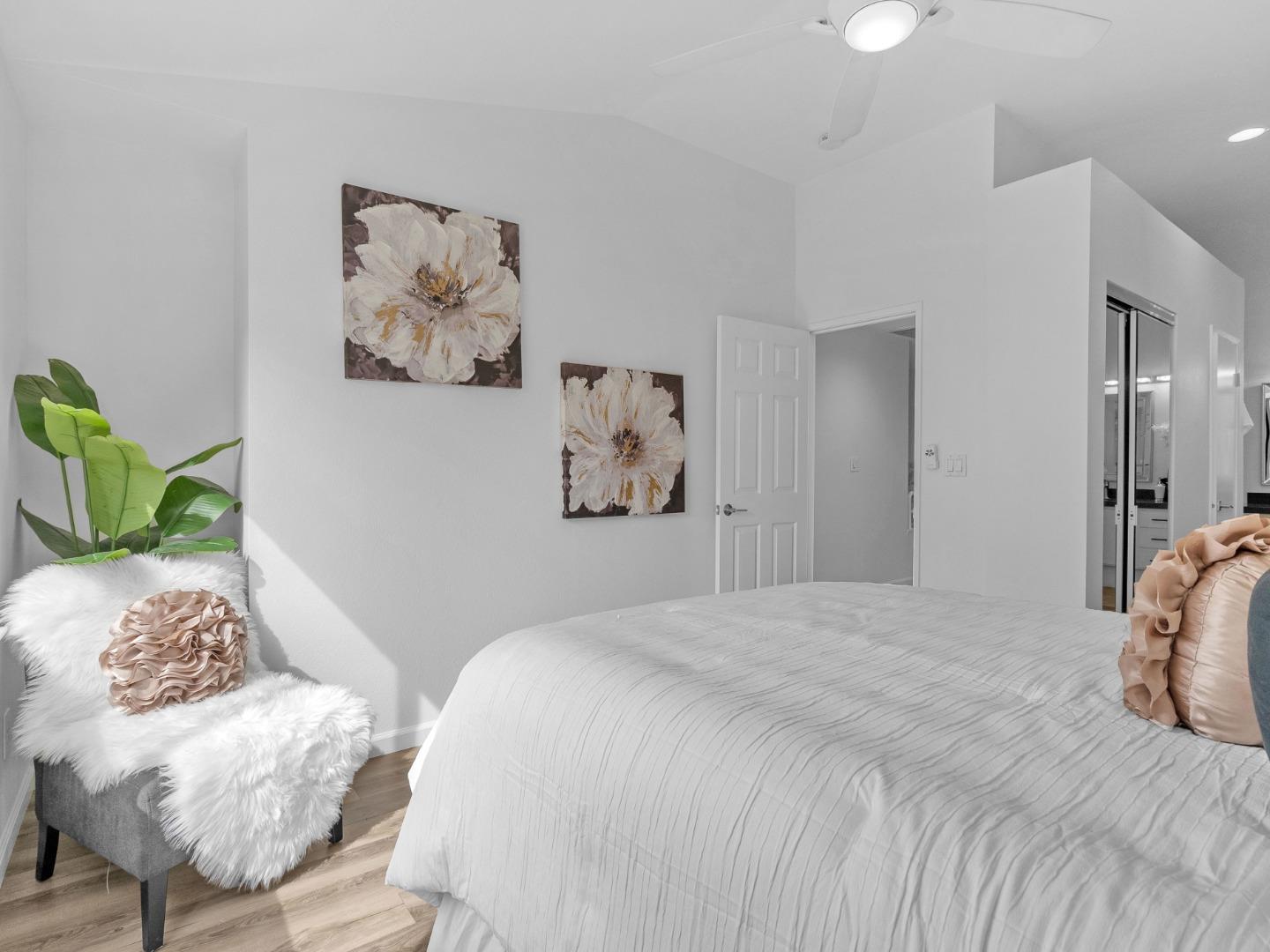 6978 Gregorich Drive, Unit E San Jose, CA 95138 - Photo 17 of 24 a bedroom with a bed and a painting on the wall