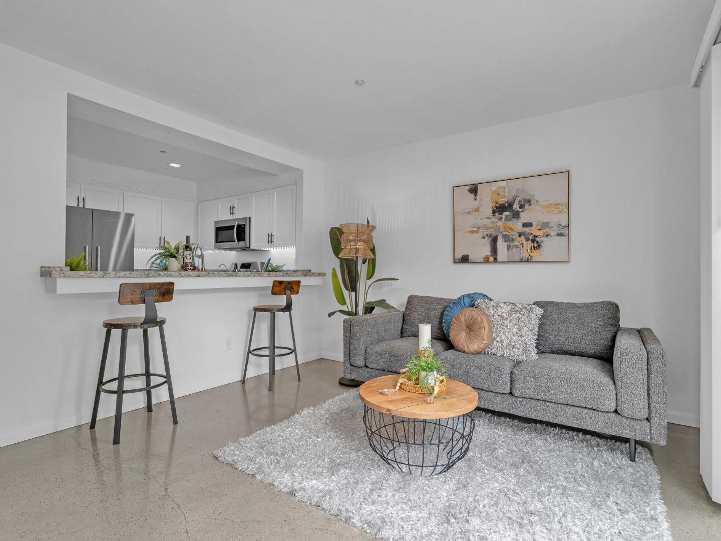 6978 Gregorich Drive, Unit E San Jose, CA 95138 - Photo 4 of 24 a living room with furniture and a table