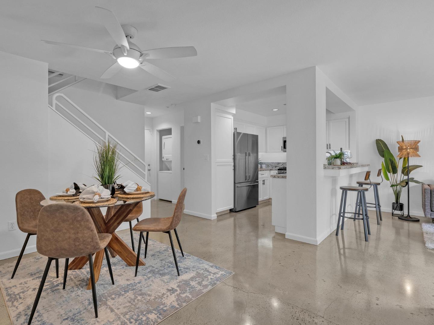 6978 Gregorich Drive, Unit E San Jose, CA 95138 - Photo 8 of 24 a view of a dining room with furniture and a chandelier