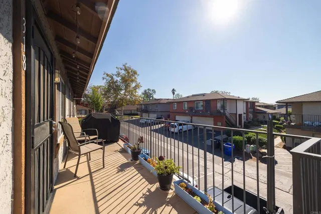 a view of garage with a car parked in front of it