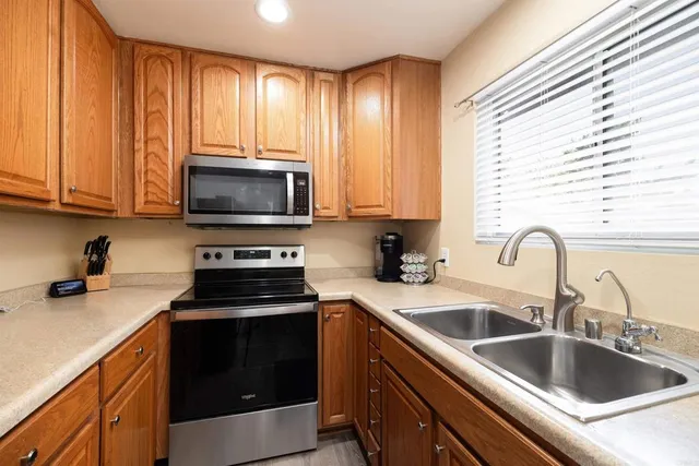 a kitchen with a sink and a stove top oven