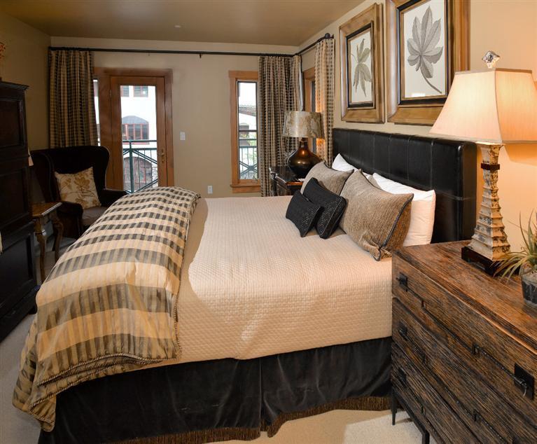 63 Avondale Lane, Unit R215 Beaver Creek, CO 81620 - Photo 11 of 26 a bedroom with a bed a lamp on dresser and a window