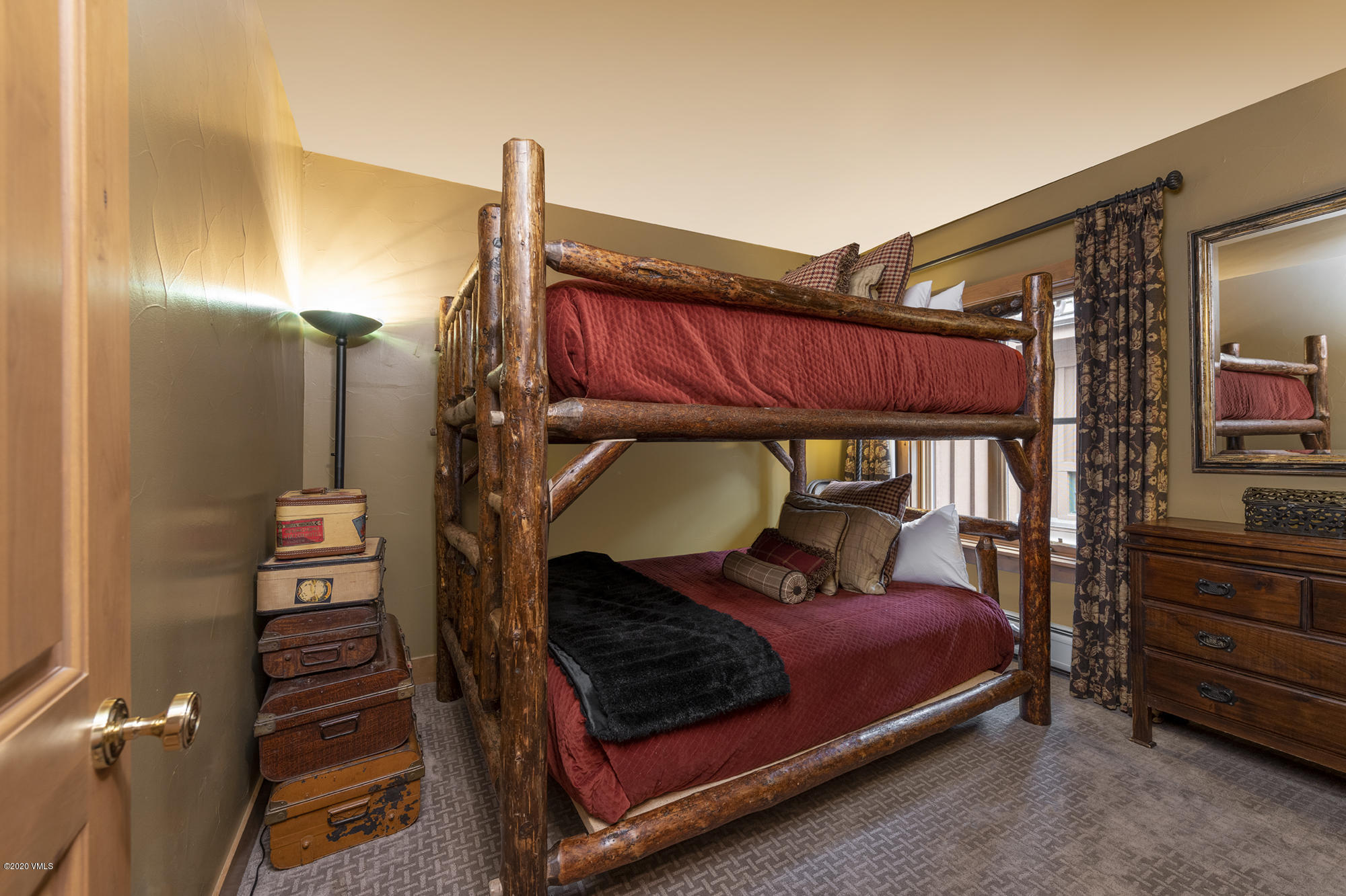 63 Avondale Lane, Unit R215 Beaver Creek, CO 81620 - Photo 15 of 26 a bedroom with a bed and wooden floor