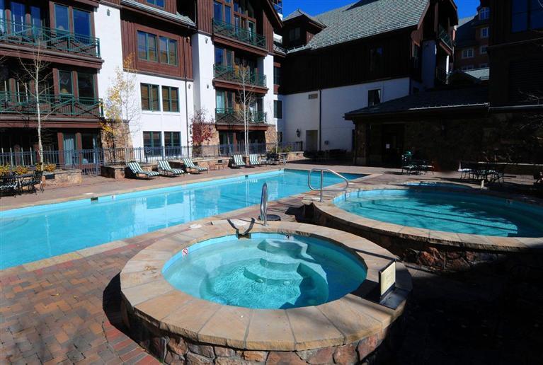 63 Avondale Lane, Unit R215 Beaver Creek, CO 81620 - Photo 25 of 26 a swimming pool with outdoor seating and yard