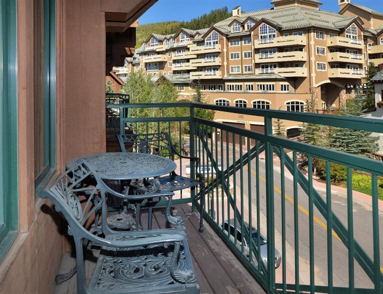 63 Avondale Lane, Unit R215 Beaver Creek, CO 81620 - Photo 3 of 26 a view of a balcony with a table and chairs