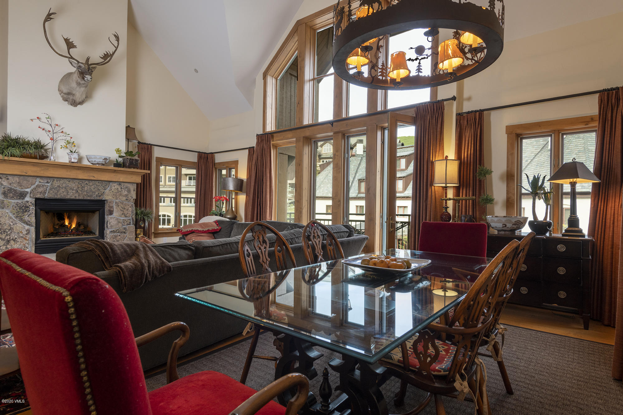 63 Avondale Lane, Unit R215 Beaver Creek, CO 81620 - Photo 4 of 26 a dining room with furniture a floor to ceiling windows and a rug
