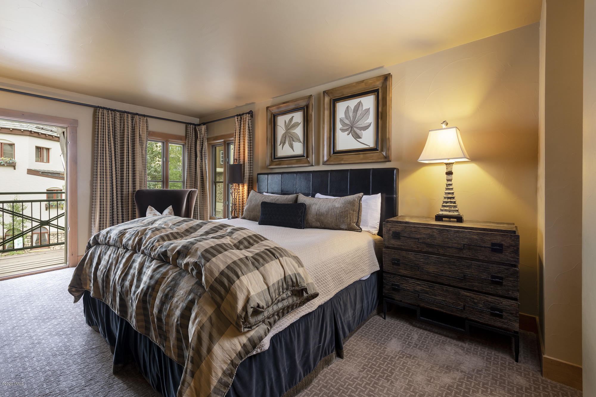 63 Avondale Lane, Unit R215 Beaver Creek, CO 81620 - Photo 10 of 26 a bedroom with a bed and wooden floor