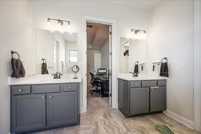 a spacious bathroom with a double vanity sink and a mirror