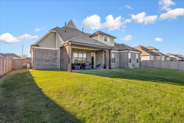 a front view of a house with a garden and plants