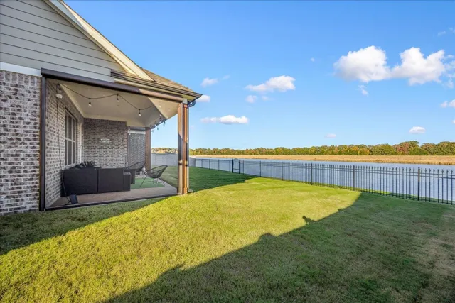 a view of swimming pool with outdoor seating and yard