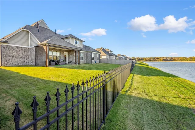 a view of a house with swimming pool and a yard