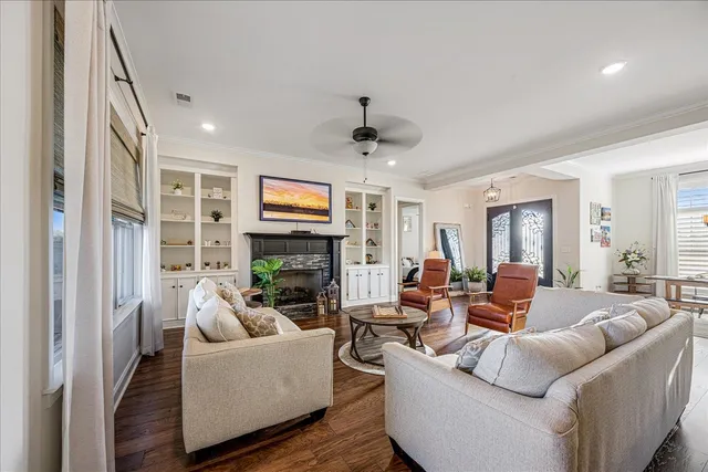a living room with furniture a fireplace and a flat screen tv