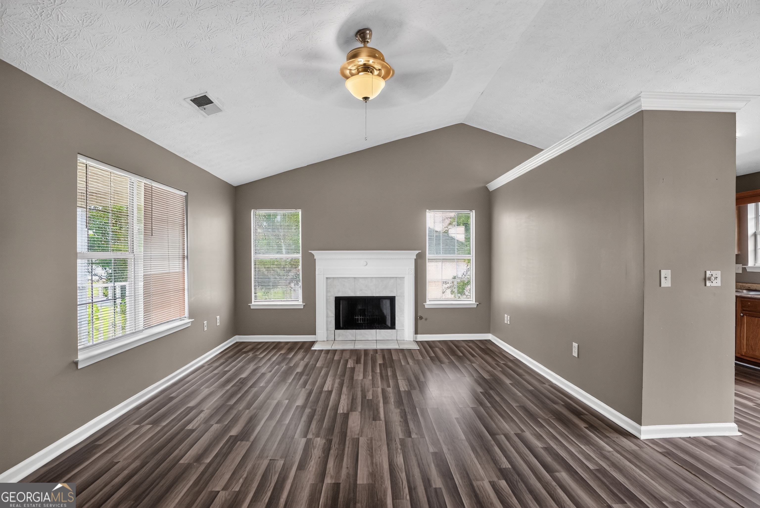 75 Linsley Way Covington, GA 30016 - Photo 22 of 48 wooden floor fireplace and windows in an empty room