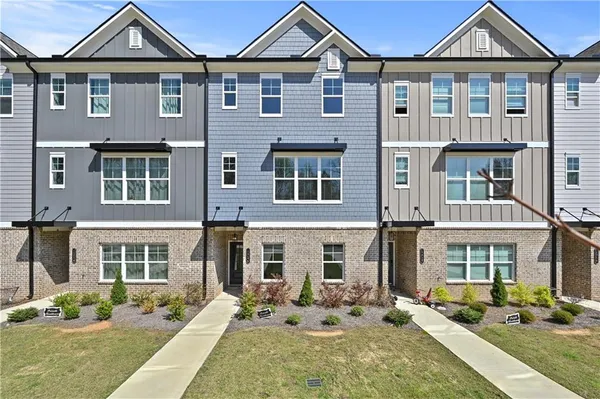 a front view of a residential apartment building with a yard