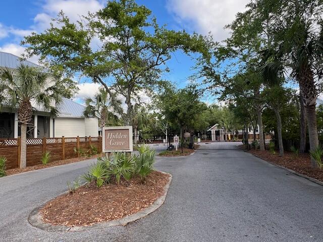 a view of a street with a house in the background