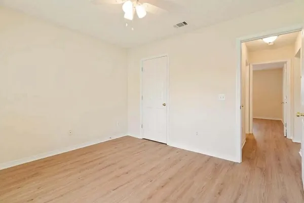 a view of a room with wooden floor