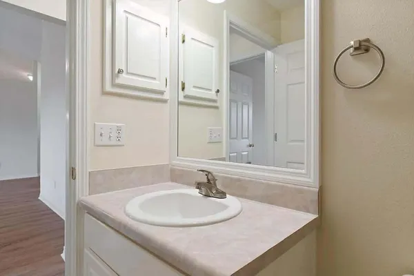 a bathroom with a granite countertop sink and a mirror