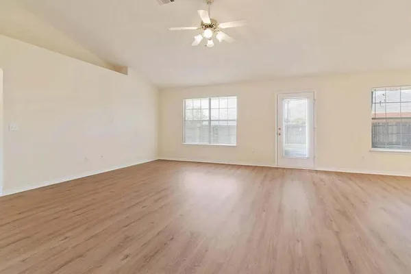 wooden floor in an empty room with a window