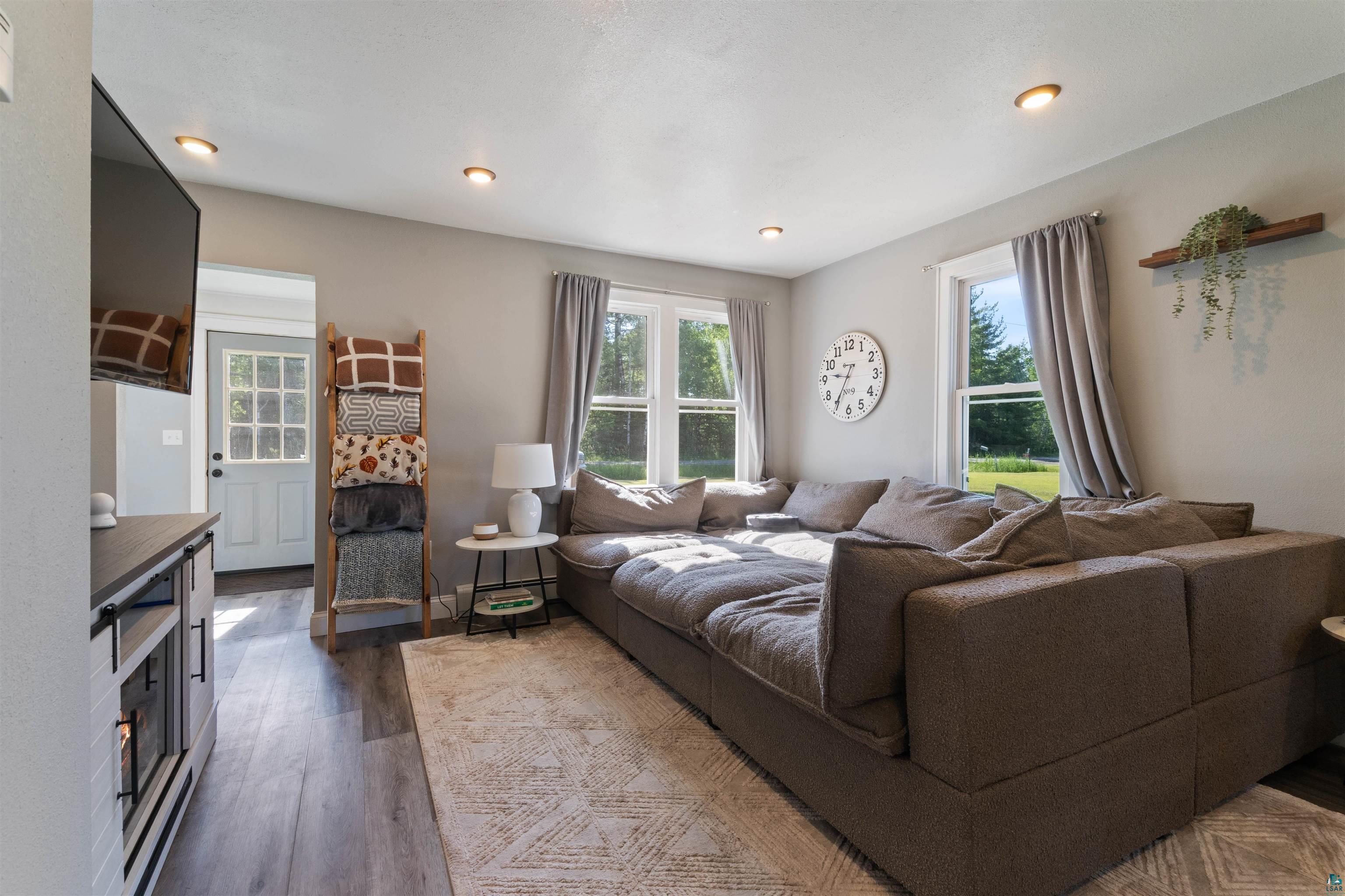 3835 South County Rd K South Range, WI 54874 - Photo 12 of 29 Living area featuring wood-finish flooring, recessed lighting, and dual windows with exterior scenery
