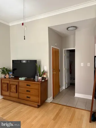 a living room with furniture and flat screen tv