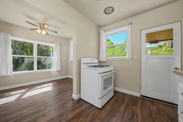 a kitchen with a stove a sink and a window