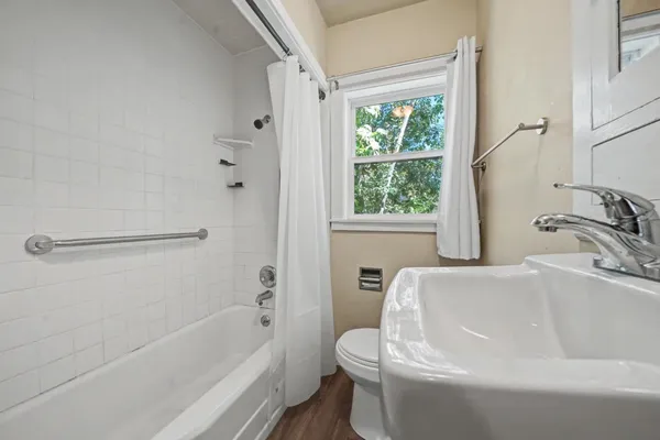 a bathroom with a sink a window and a bathtub