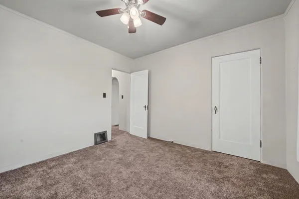 an empty room with a empty space and a ceiling fan