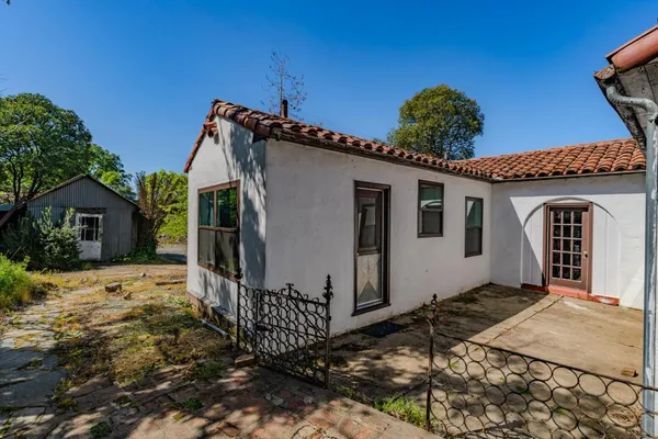a view of a house with wooden fence