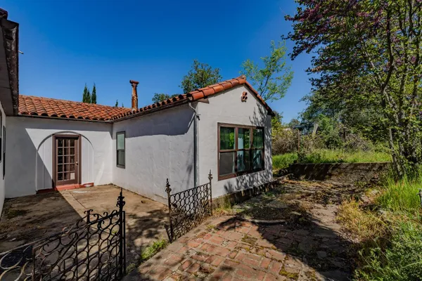 a view of a house with wooden fence
