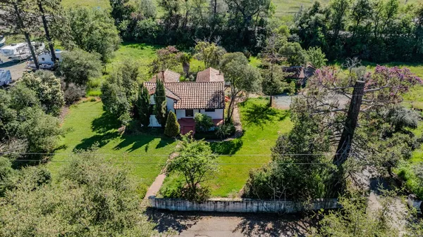 an aerial view of a house with a yard