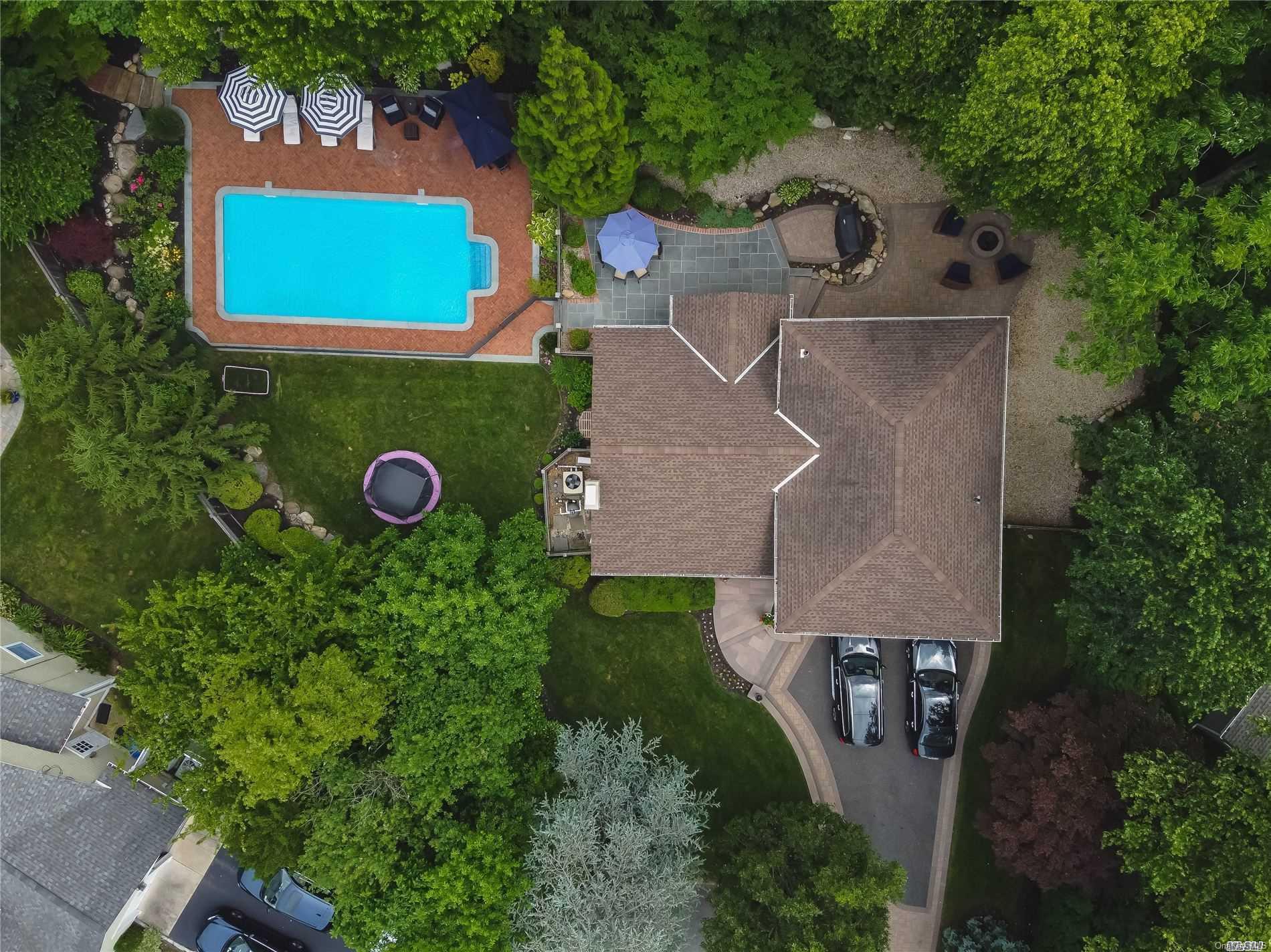 22 Fox Ridge Lane Locust Valley, NY 11560 - Photo 1 of 1 an aerial view of a house with a swimming pool a yard and a outdoor seating