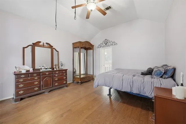 a view of a livingroom with wooden floor and a ceiling fan