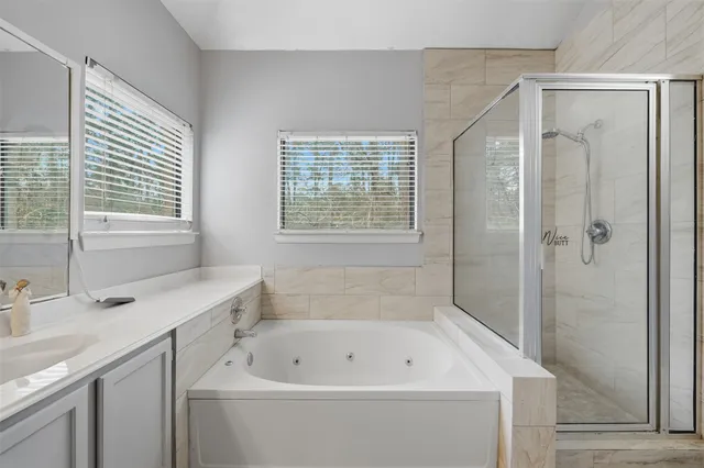 a spacious bedroom with a bed and wooden floor