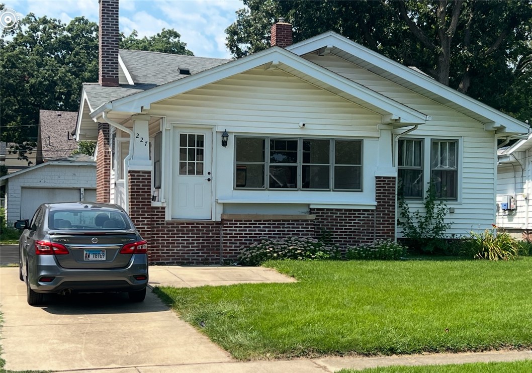 227 North Dennis Avenue Decatur, IL 62522 - Photo 1 of 1 a front view of a house with a garden