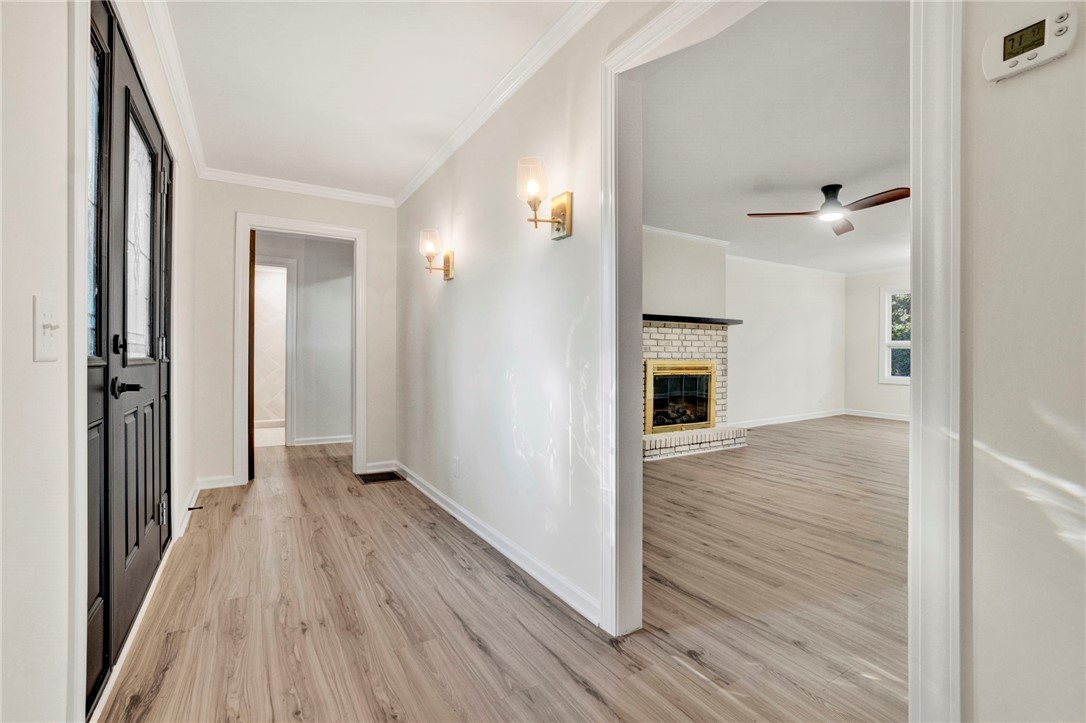237 Earle Road Central, SC 29630 - Photo 6 of 24 A welcoming entryway with warm lighting leads into a spacious living area featuring a cozy fireplace.
