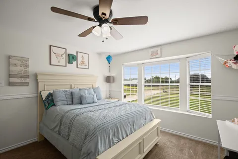 a bedroom with a large bed and a window