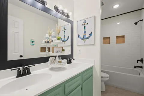 a bathroom with a double vanity sink and a mirror