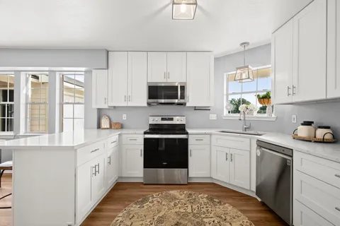 a kitchen with a stove a sink and a microwave