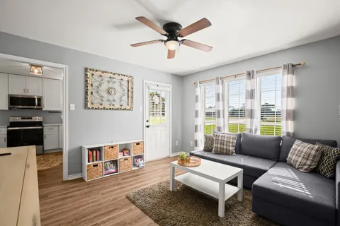 a living room with furniture and a large window