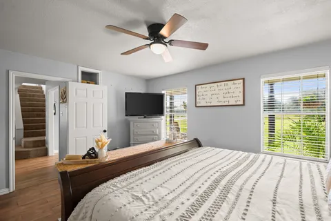 a bedroom with a bed and a flat screen tv