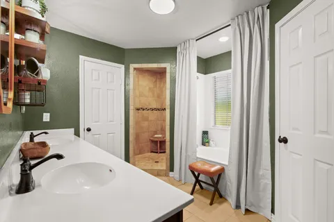 a bathroom with a tub and sink