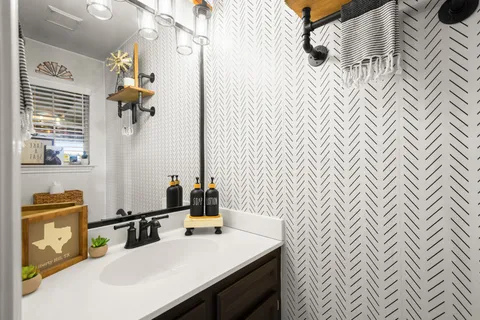 a bathroom with a sink a mirror and a shower