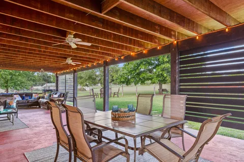 a view of a house with a big yard and a large tree