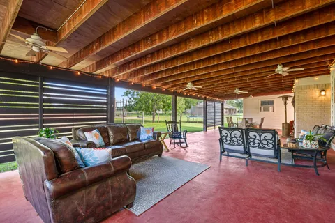 a roof deck with couch and chairs