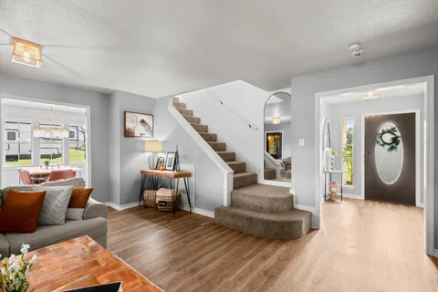 a living room with furniture and wooden floor