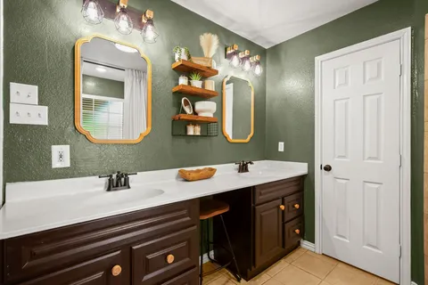 a bathroom with a double vanity sink and a mirror