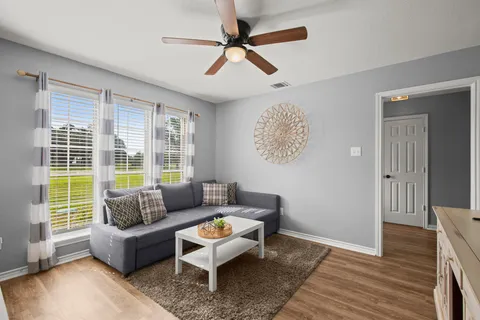 a living room with furniture and a large window