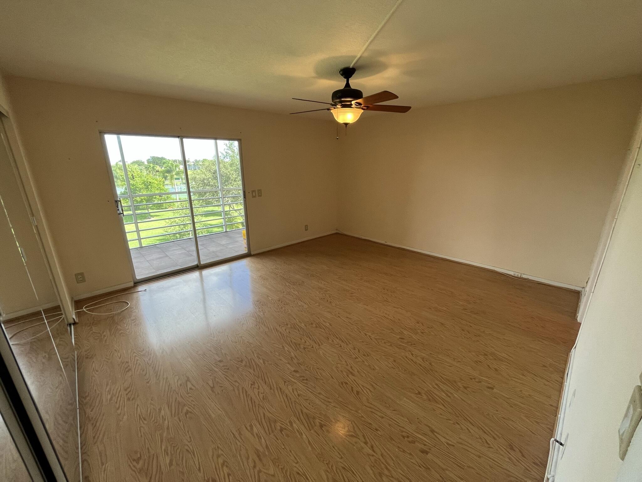 3013 Newcastle A Boca Raton, FL 33434 - Photo 12 of 19 wooden floor in an empty room with a window